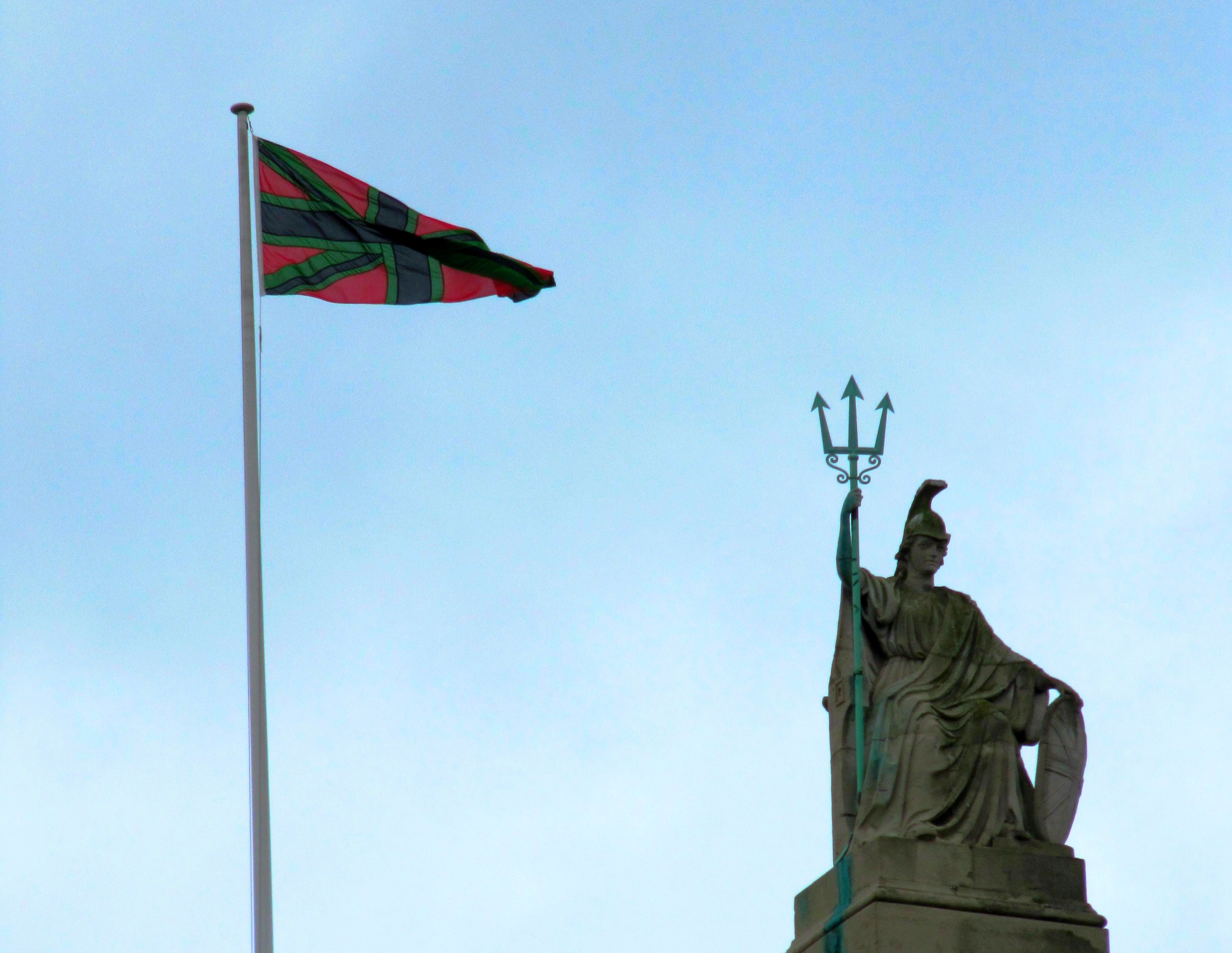 Chris Ofili's Union Black flag, in red, black and green, flying above Tate Britain beside the statue of Britannia on its roof