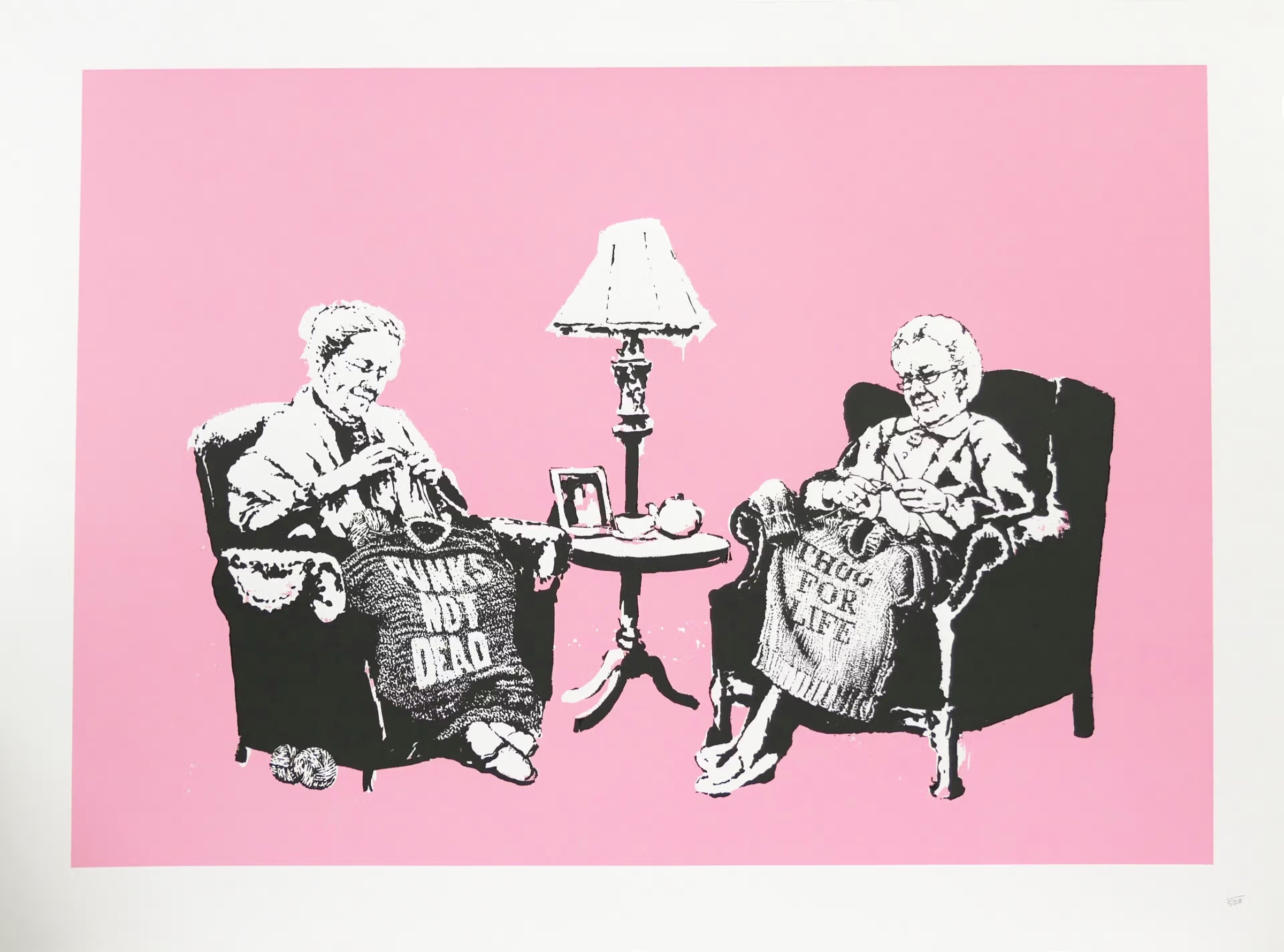 Banksy, Grannies, 2006, screenprint in black and white on pink: two old women in armchairs either side of a lamp and a tea table, knitting Punks Not Dead and Thug for Life